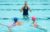 Women teaching to children to swim